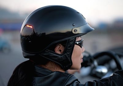 woman wearing a harley davidson half motorcycle helmet