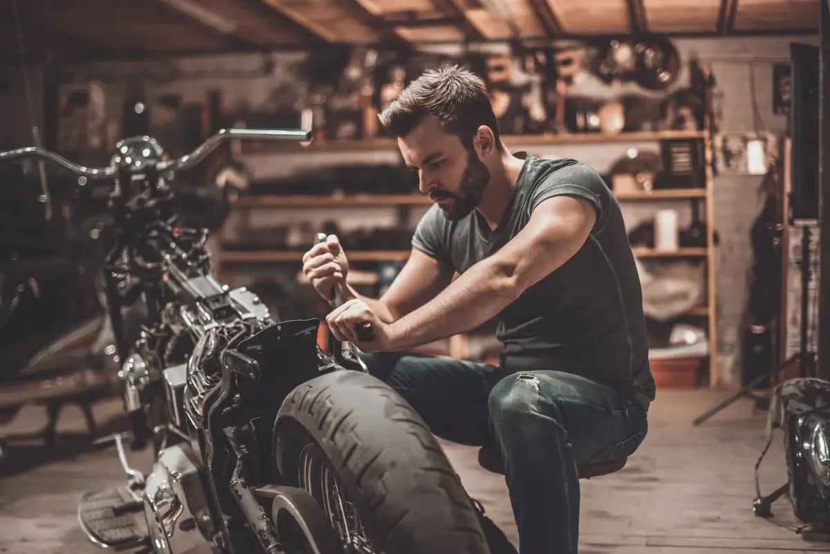 A mechanic working on a motorcycle.