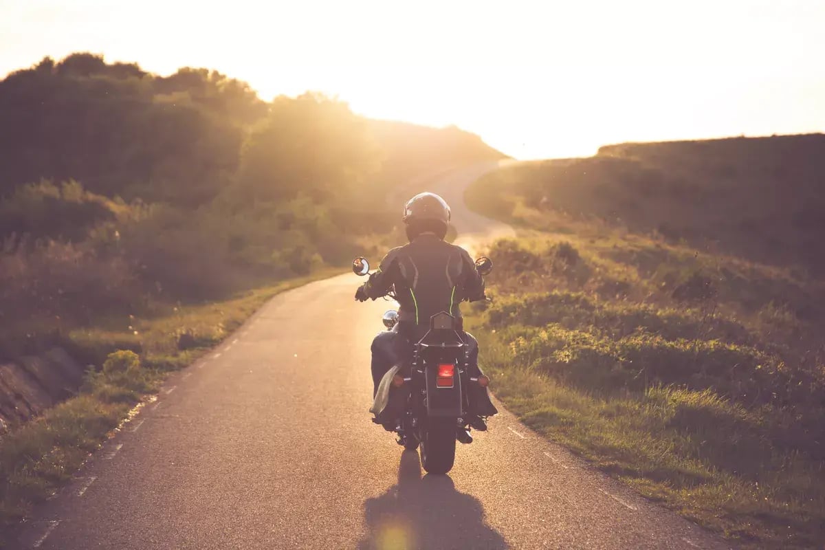 A motorcyclist on a mountain road.