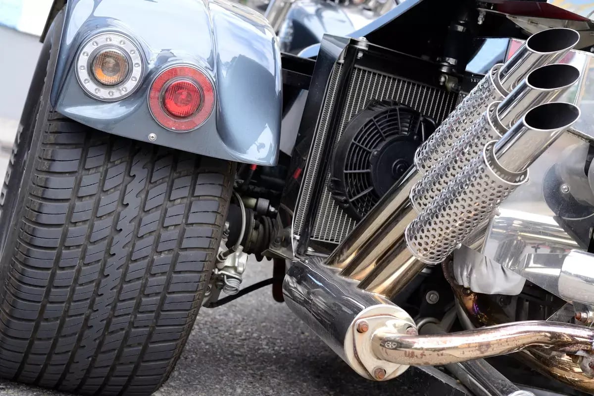 Closeup of a special motorcycle - exhaust and tire of a trike