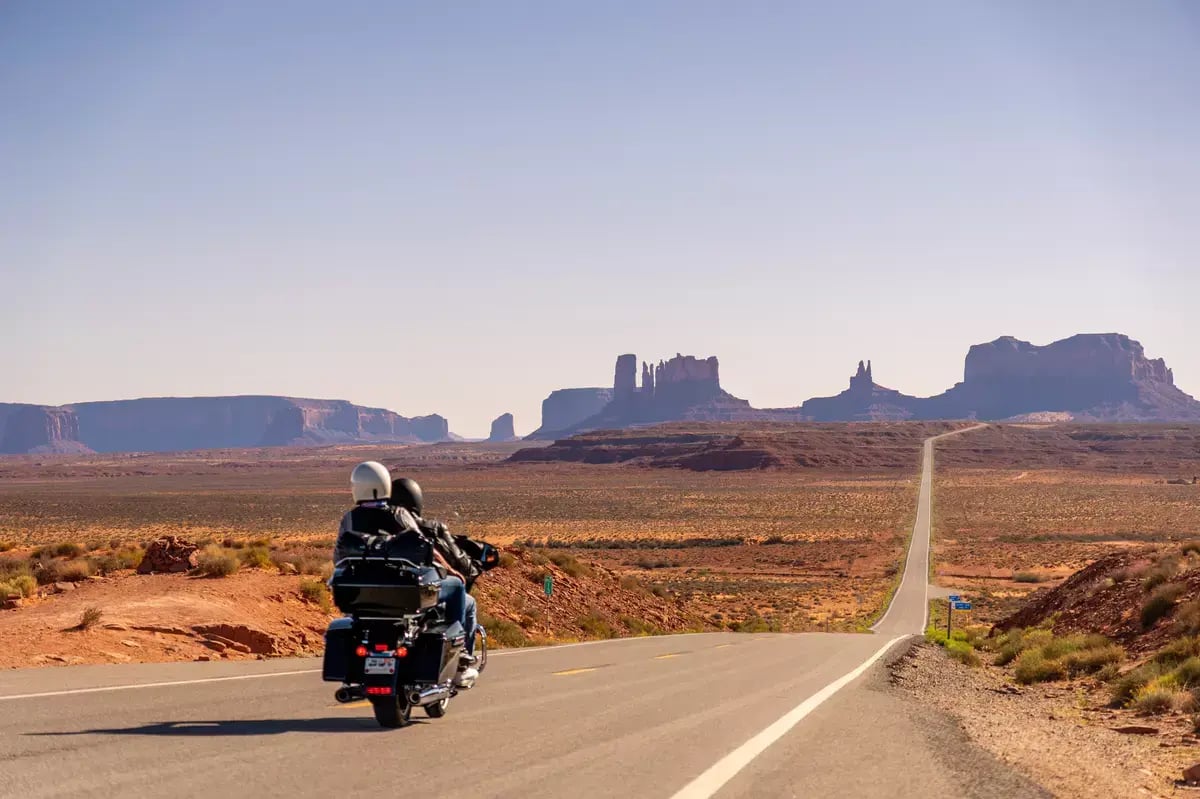 Couple on Route 66 motorcycle trip at Monument Valley