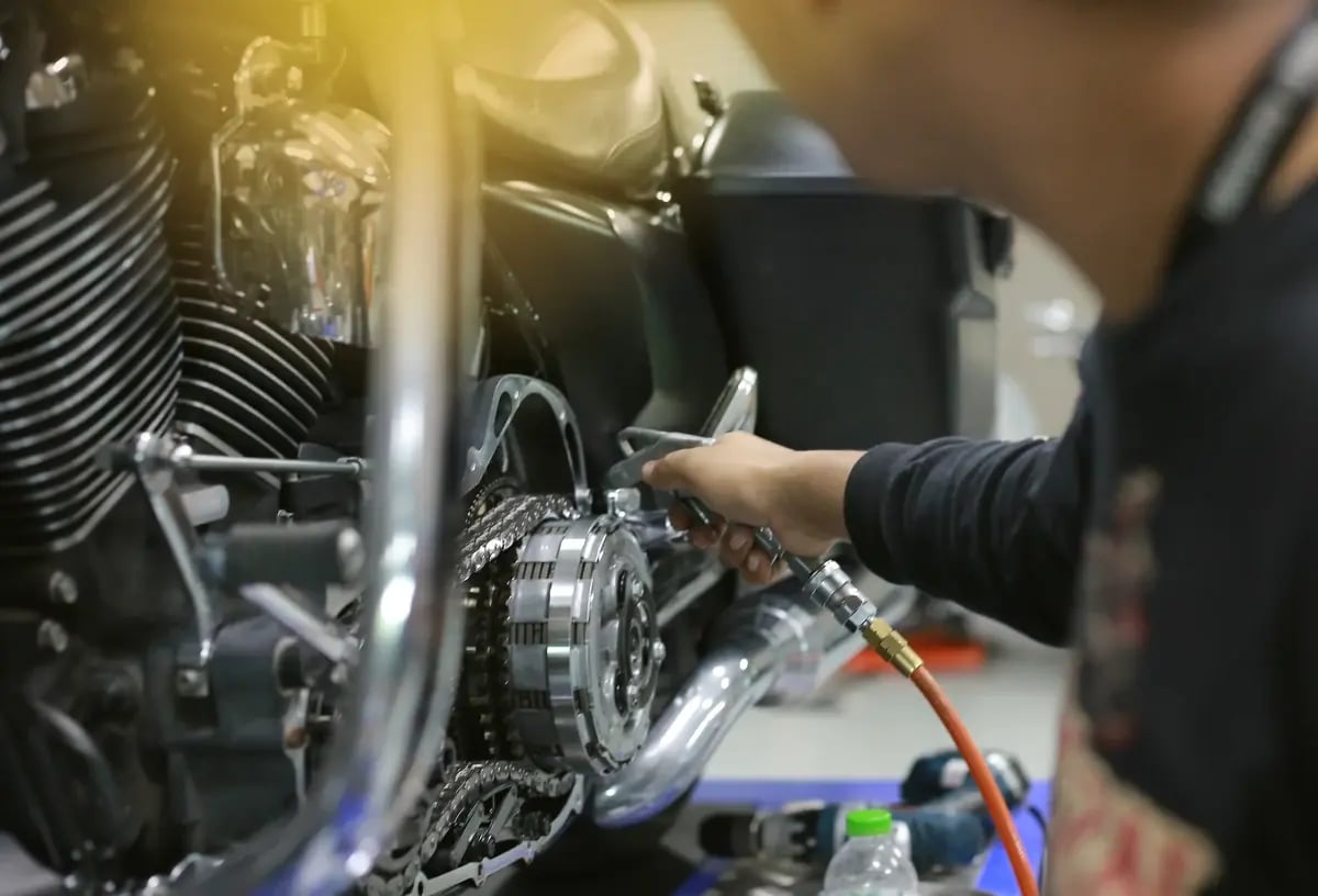 Technician used air blower to blow all dust & dirty stuff away from engine of motorbike